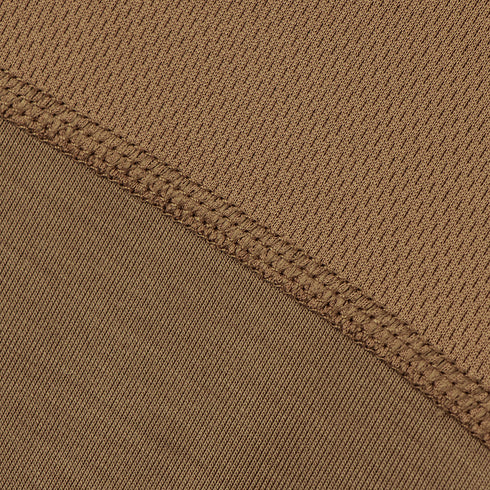 Close-up of Condor Short Sleeve Combat Shirt Gen II’s brown, moisture-wicking fabric shows visible stitching and a diagonal seam dividing ribbed and smooth textures.